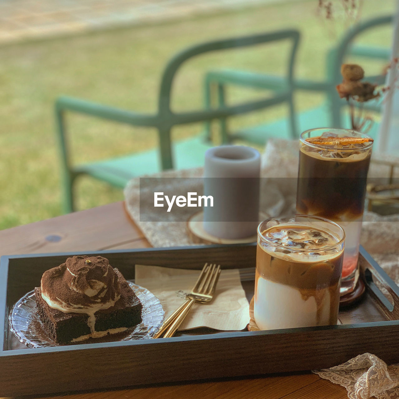 COFFEE CUP ON TABLE AGAINST GLASS