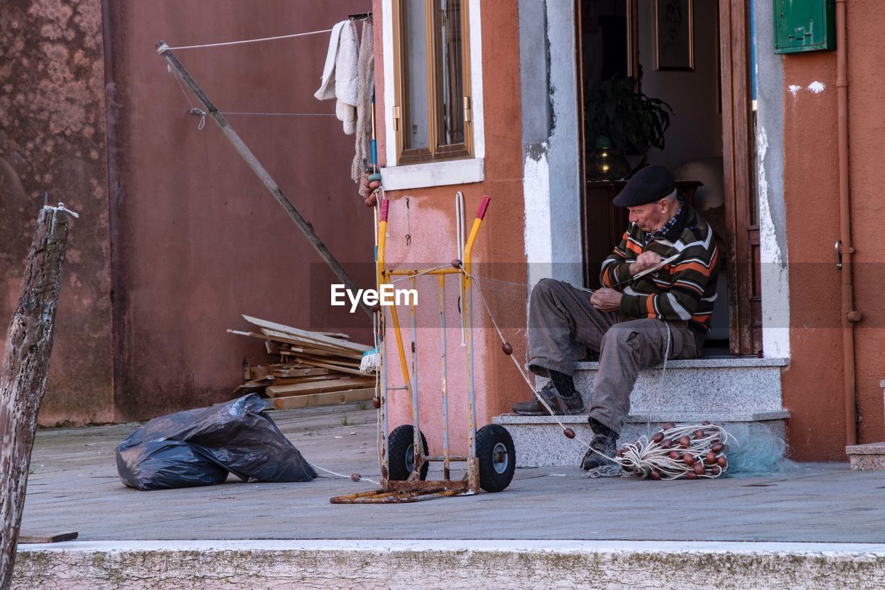 PEOPLE WORKING ON ENTRANCE OF HOUSE