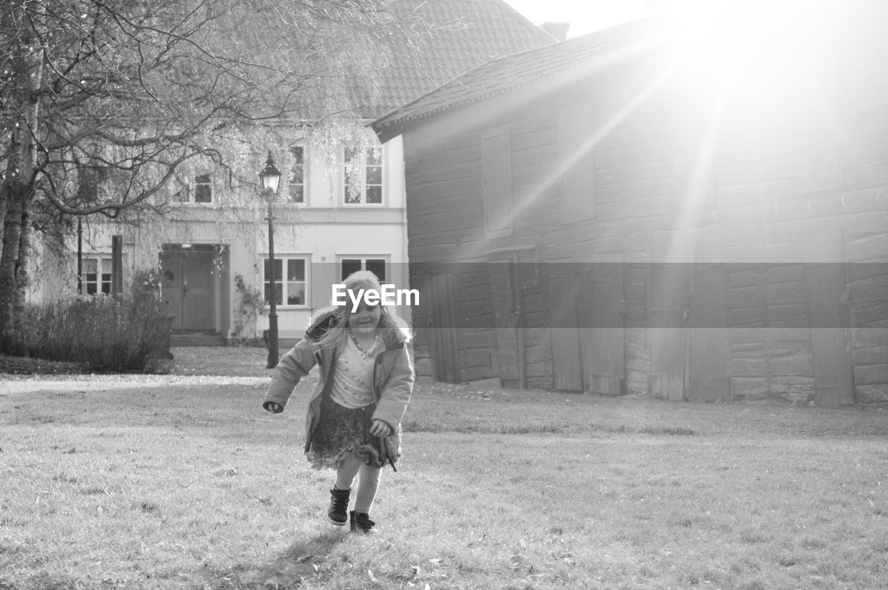 Full length of cute girl running on land during sunny day