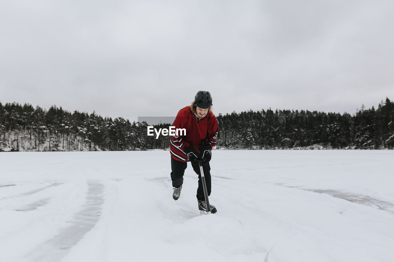 Man ice-skating on frozen lake