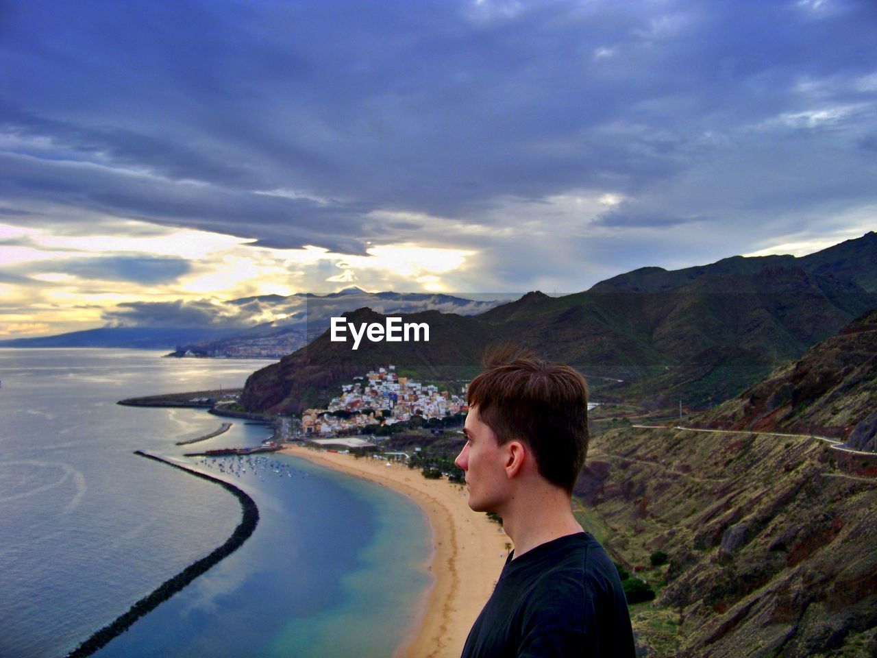 Side view of man against mountains during sunset