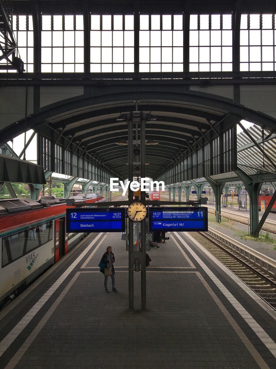 High angle view of woman standing on railroad platform