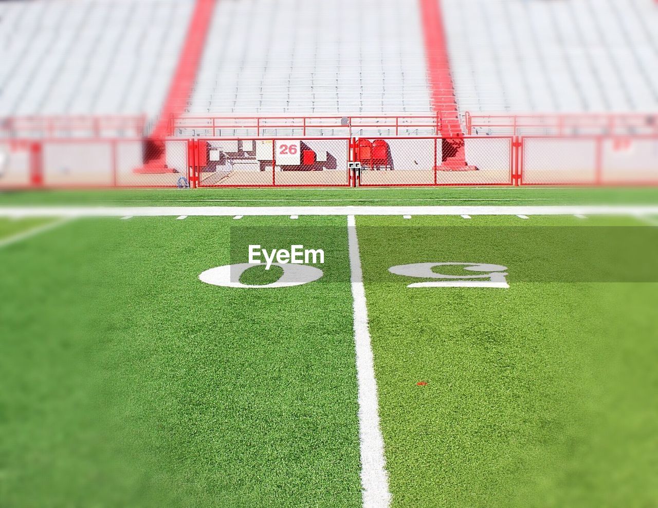 CLOSE-UP OF SOCCER BALL ON FIELD AGAINST WALL