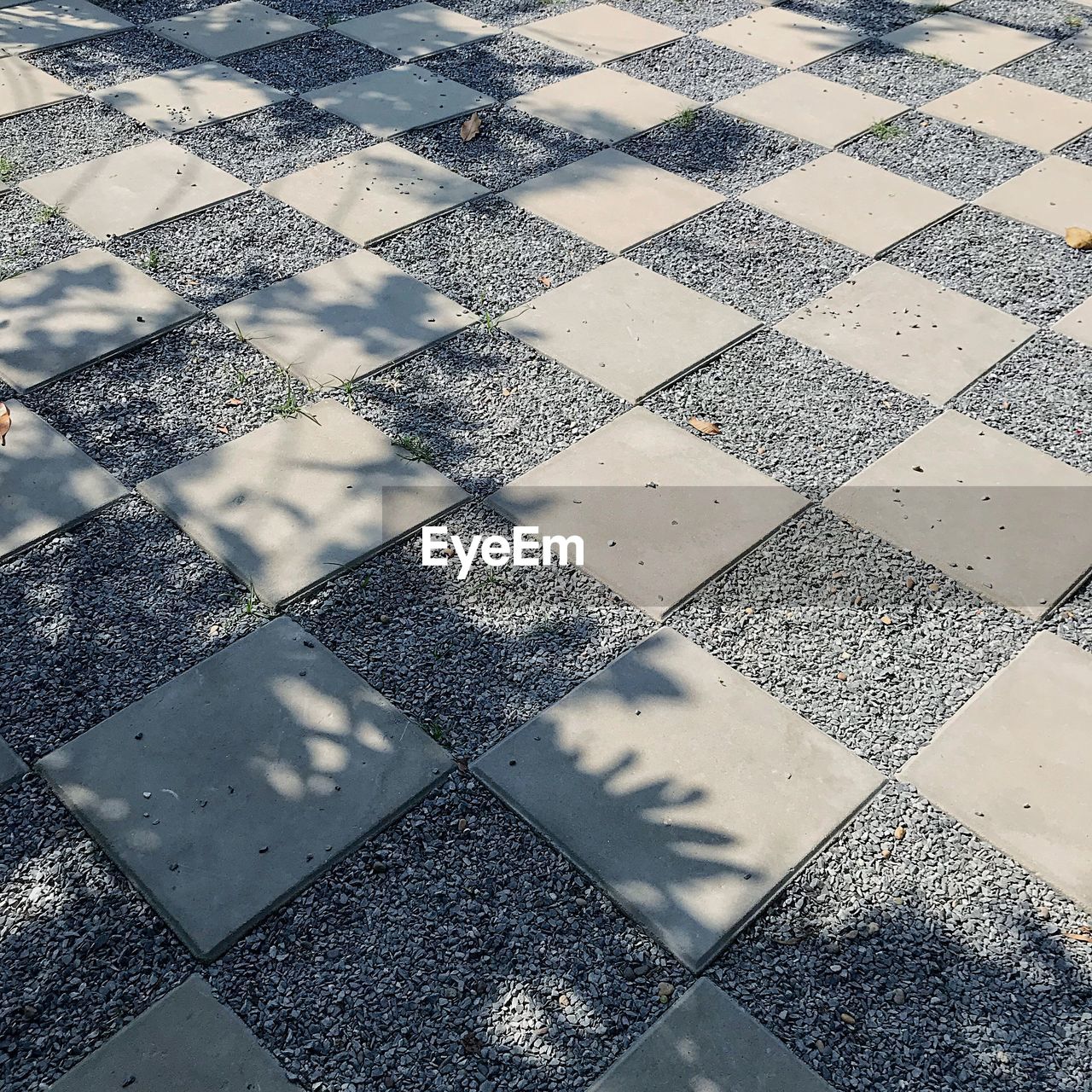 FULL FRAME SHOT OF TILED FLOOR WITH SHADOW