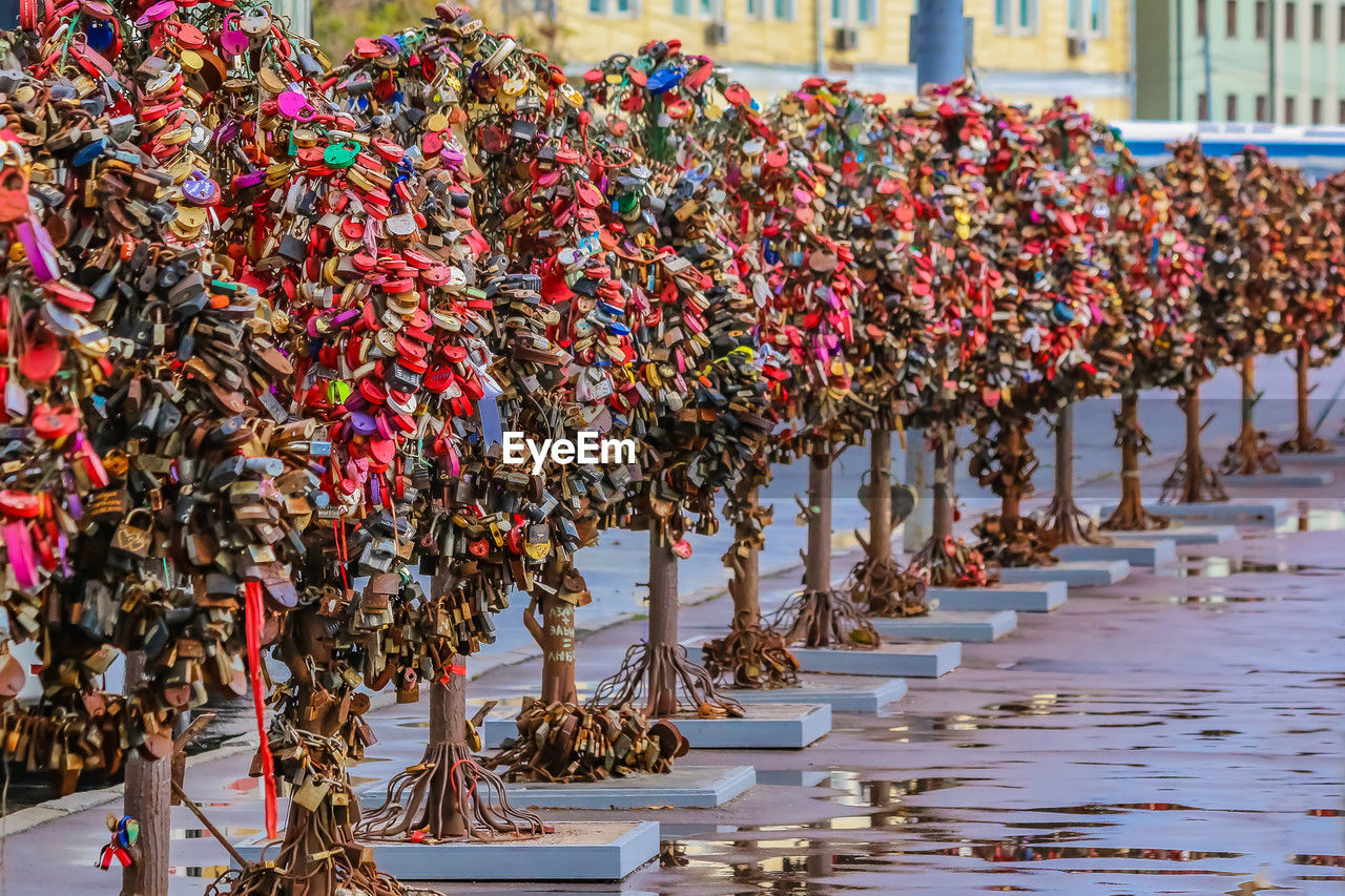 crowd, architecture, day, abundance, large group of objects, outdoors, tradition, built structure, nature, in a row, city, celebration, security, marching, padlock, protection, lock, street, flower, hanging