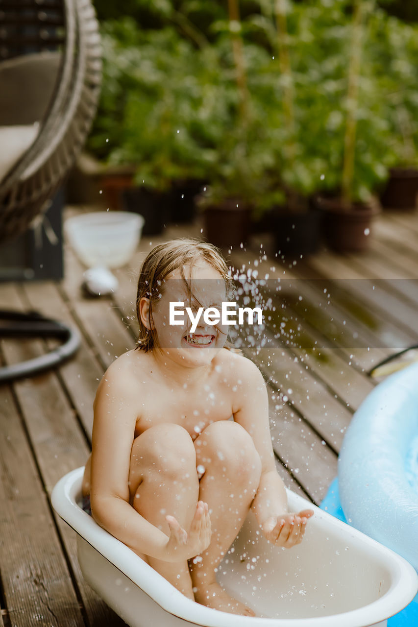 Portrait of smiling boy in water