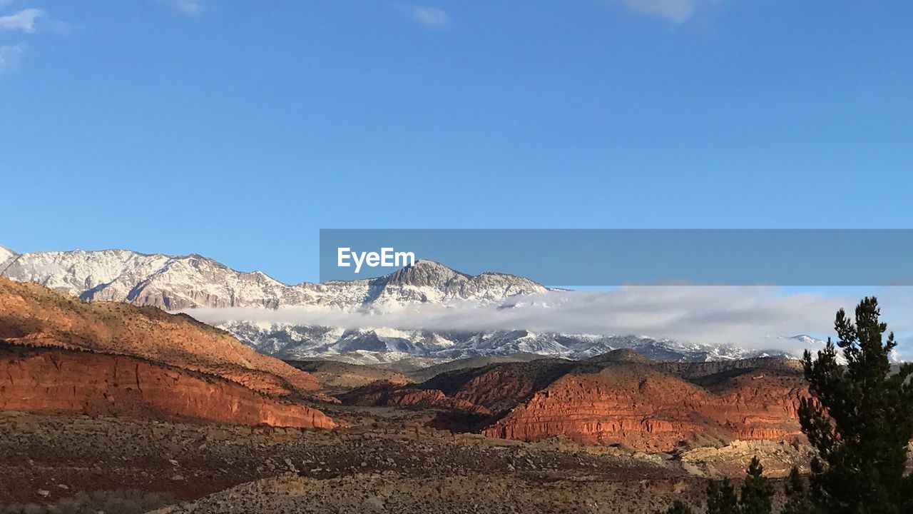 Scenic view of mountains against clear blue sky