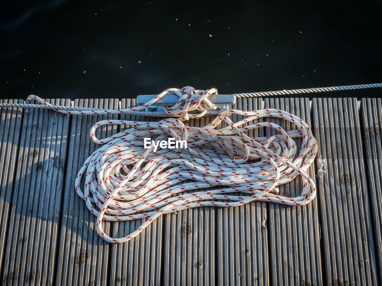 High angle view of rope tied on pier