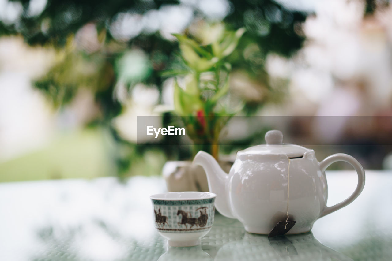 CLOSE-UP OF COFFEE CUP ON TABLE DURING MONSOON