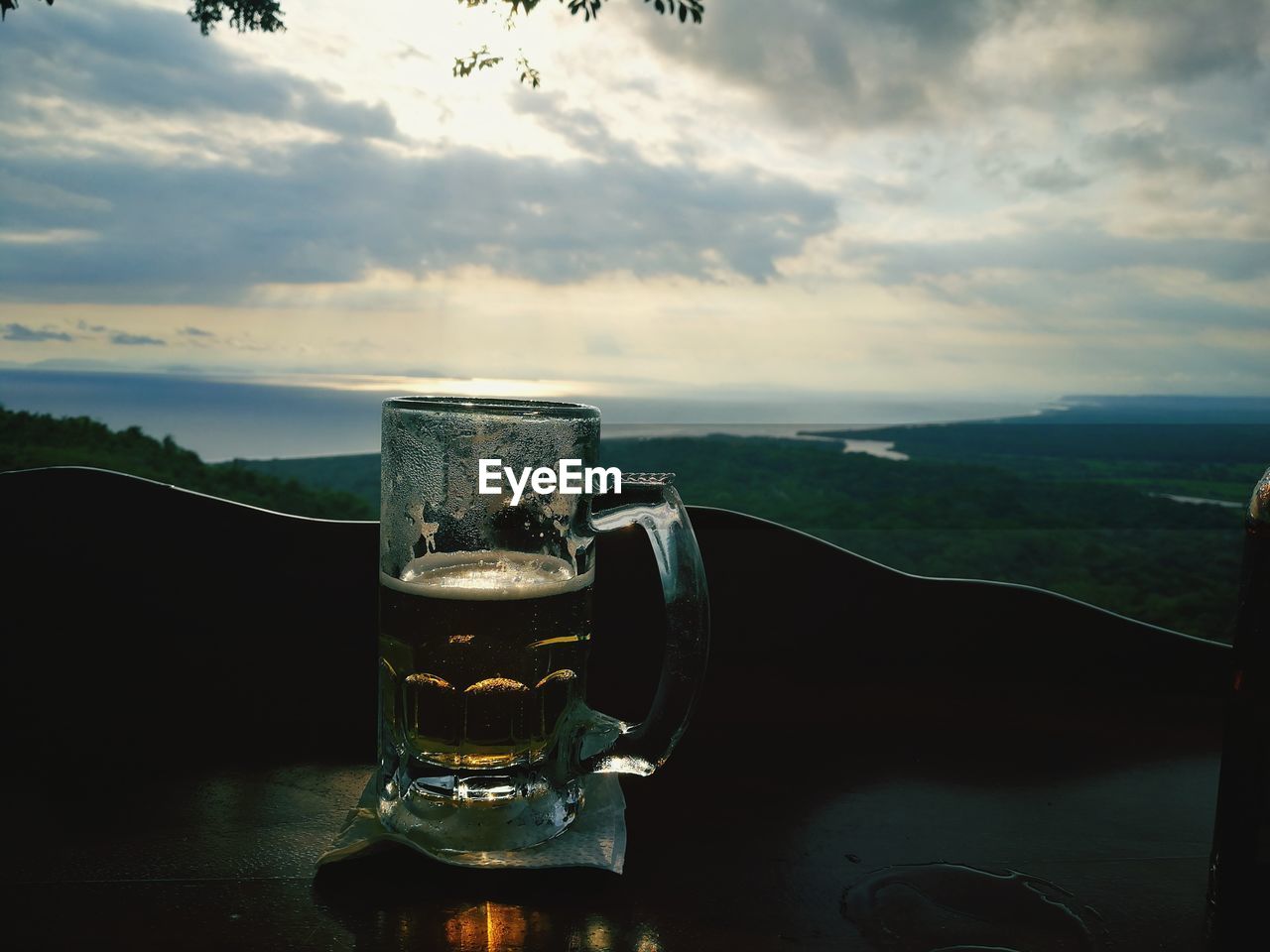 CLOSE-UP OF BEER GLASS ON TABLE