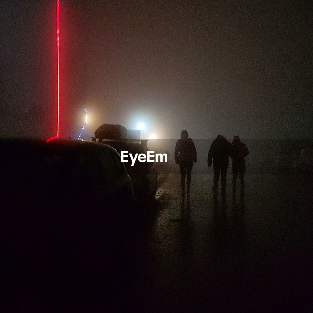 SILHOUETTE MEN IN ILLUMINATED NIGHT SKY