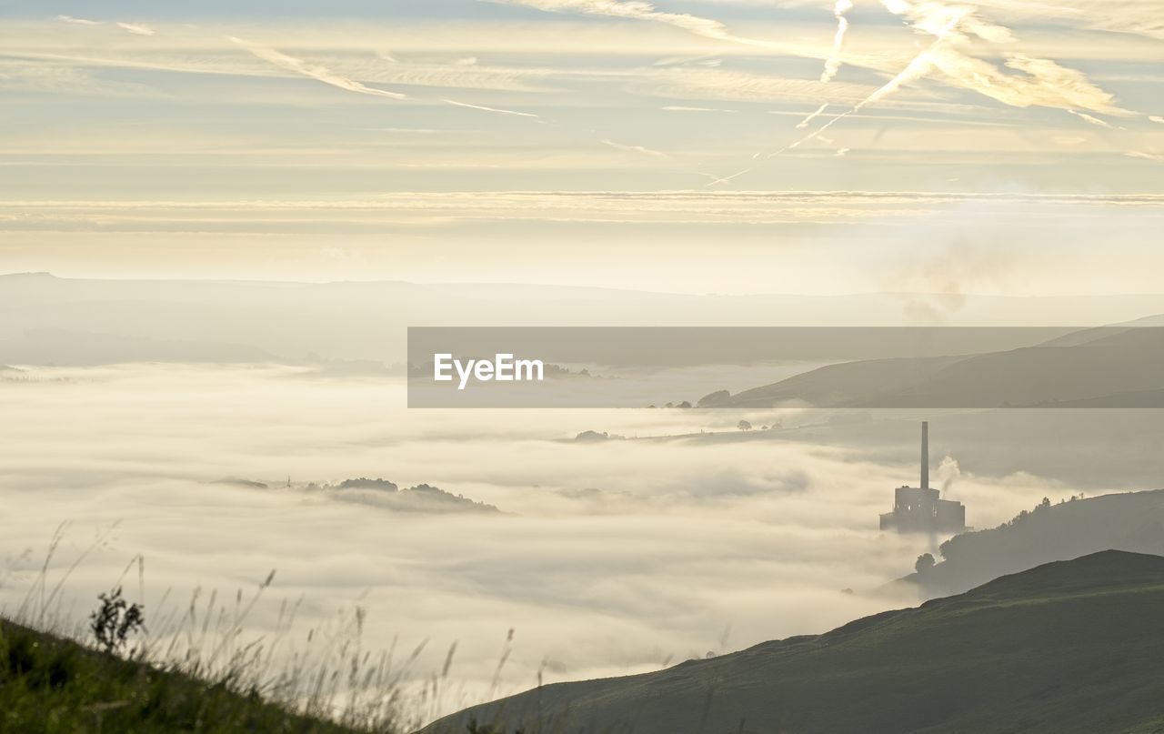Scenic view of mountains against sky during sunrise sunset with cloud inversion 