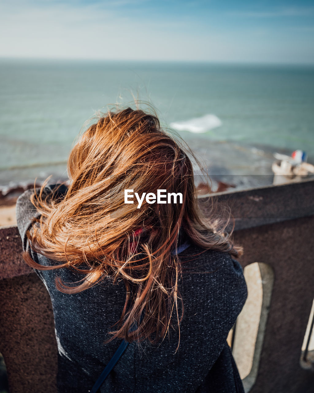 Rear view of woman looking at sea against sky