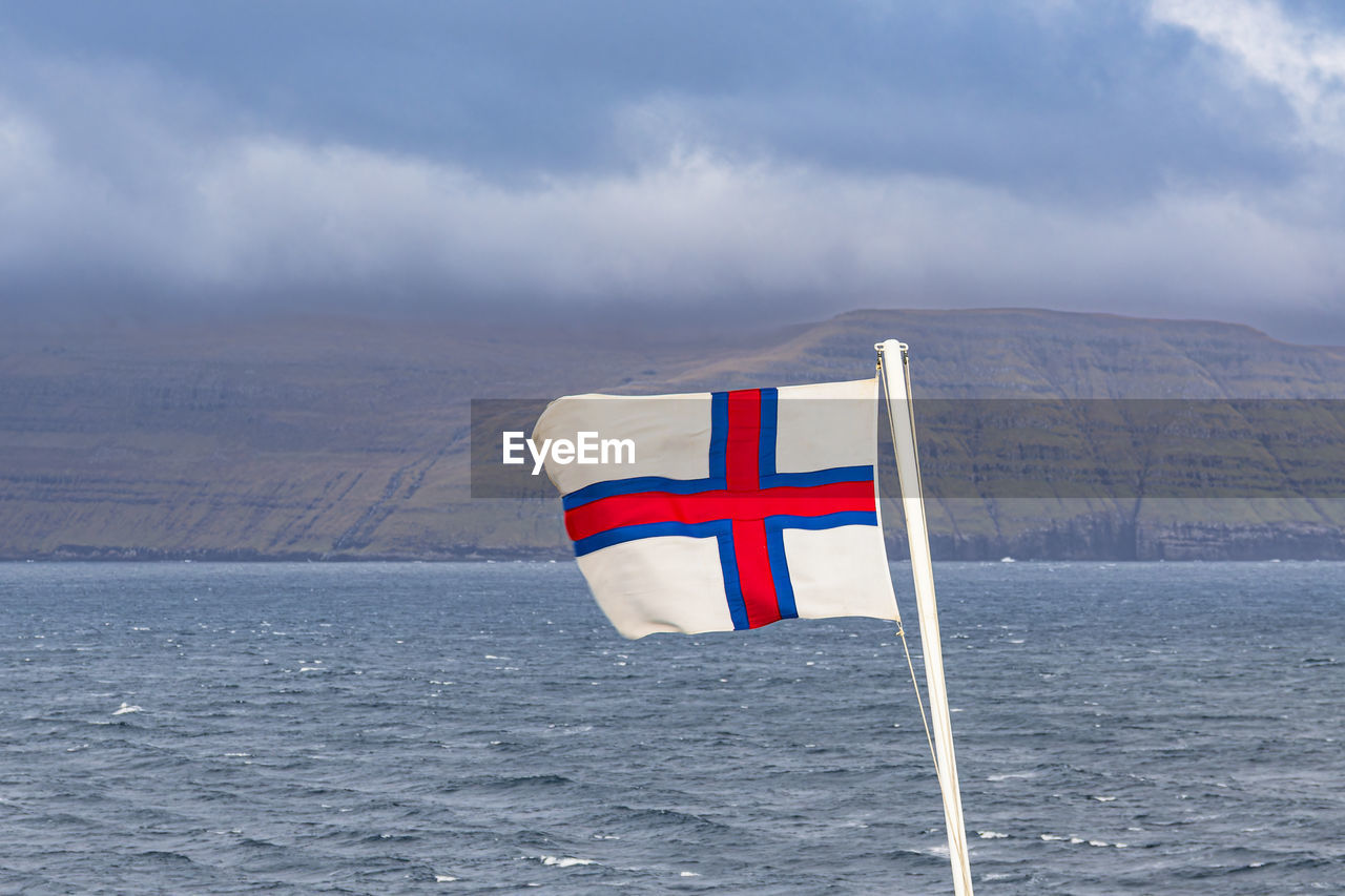 view of flag on sea against sky