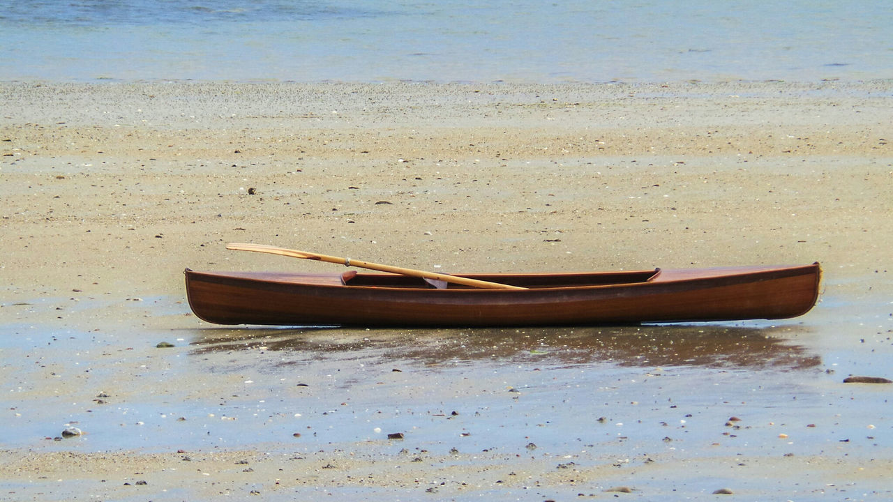 BOAT MOORED ON SHORE