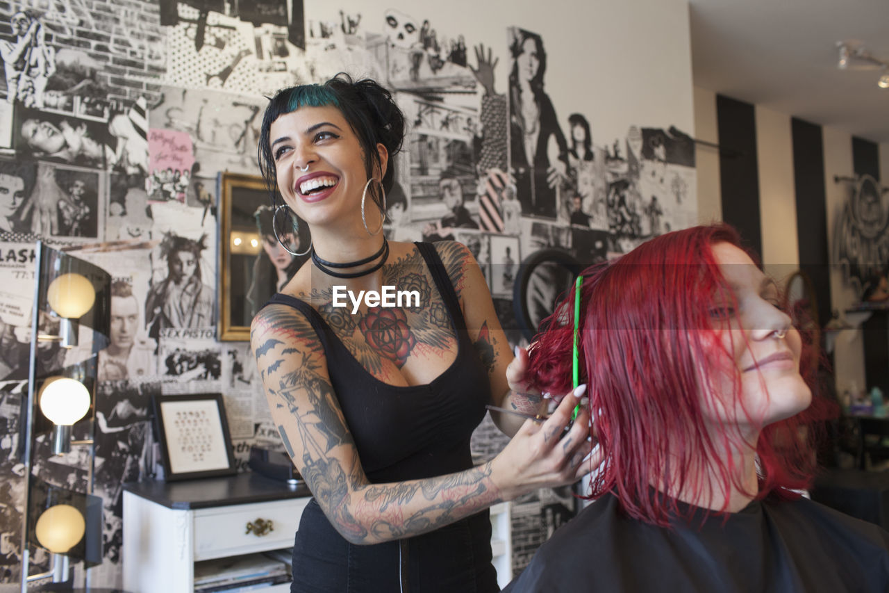 A hair dresser styling a customer's hair.