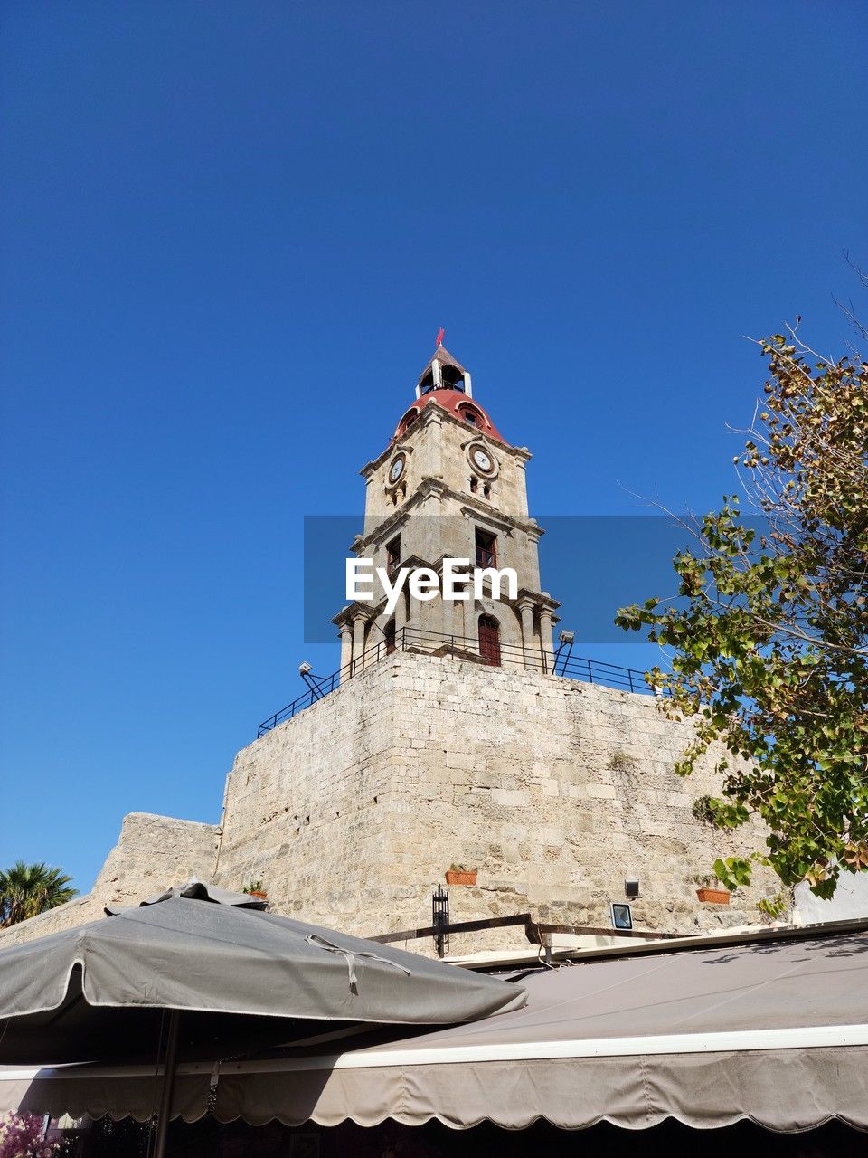 architecture, sky, clear sky, blue, nature, built structure, building exterior, tree, low angle view, day, building, no people, sunny, plant, outdoors, sunlight, travel destinations, city, history, the past, religion, travel