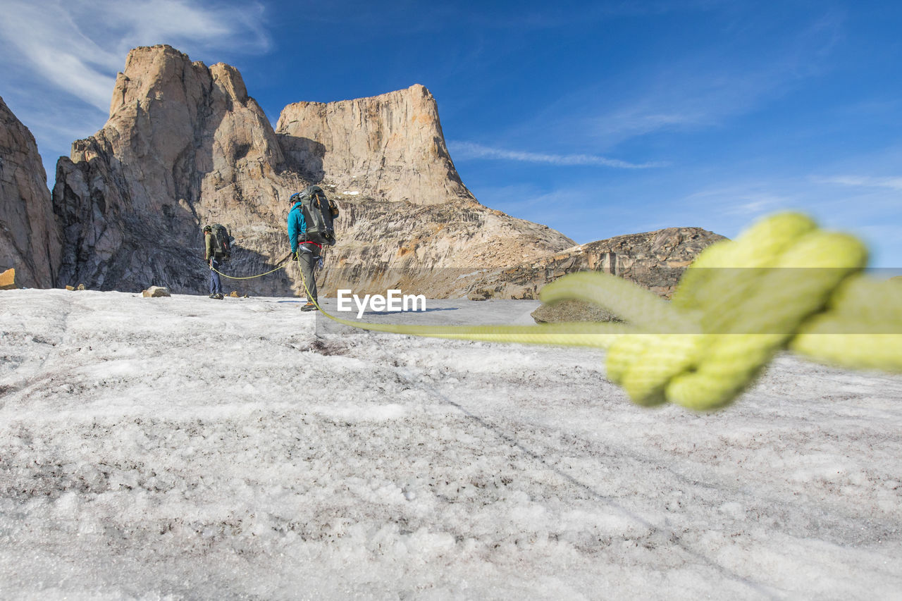 Detail of climbing rope attached to climbing team in the mountains.