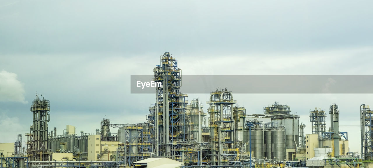 Petrochemical industrial plant with dark clouds