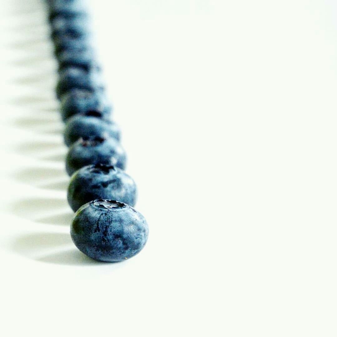 CLOSE-UP OF FRUITS OVER WHITE BACKGROUND