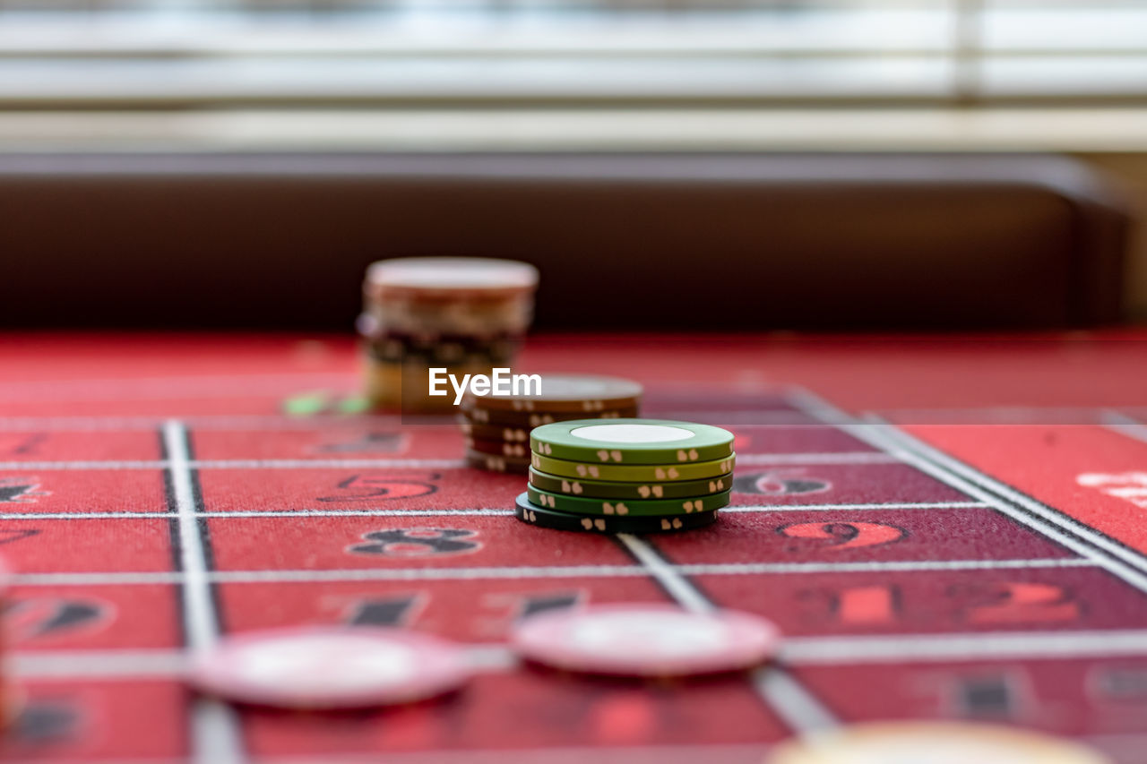 Close-up of gambling chips on table