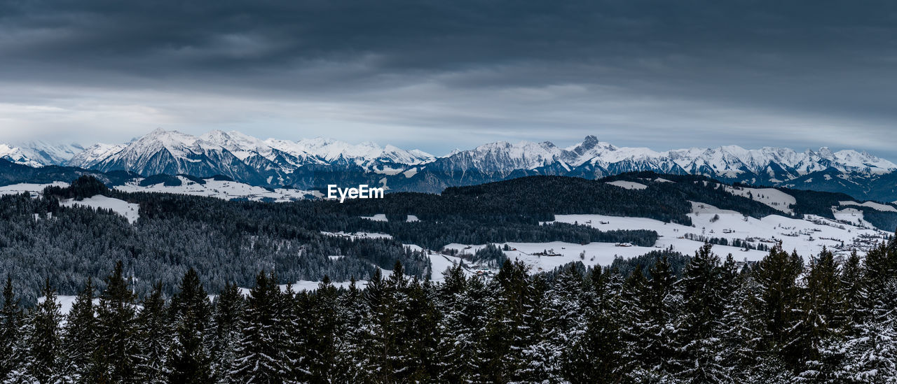 Scenic view of snowcapped mountains against sky