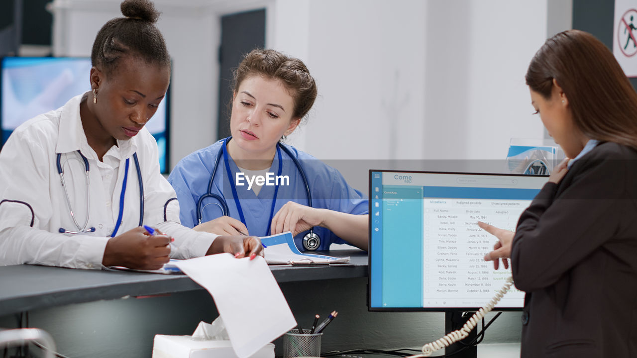 doctor working at table in office