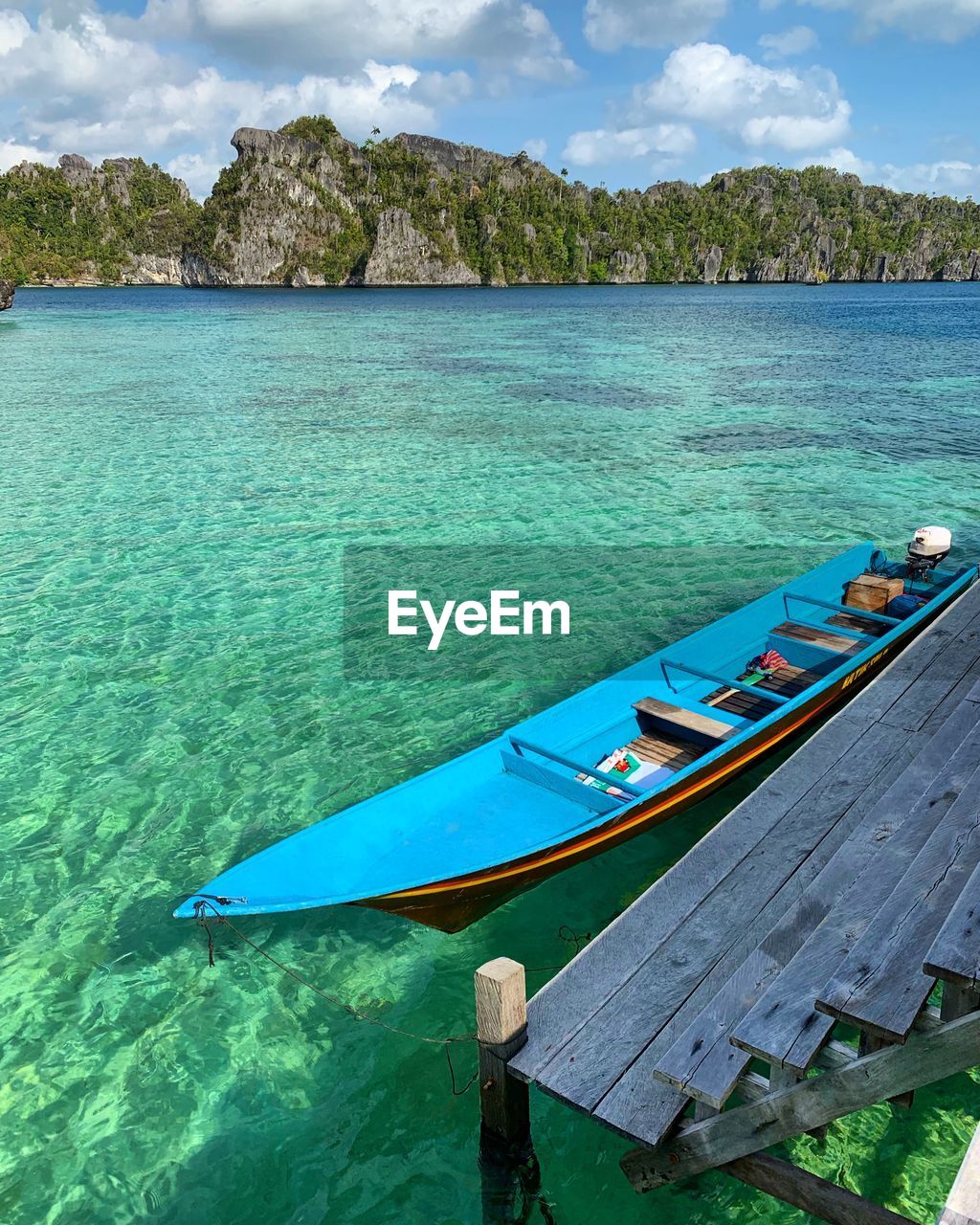 Scenic view of sea against sky with boat at misool raja ampat island 