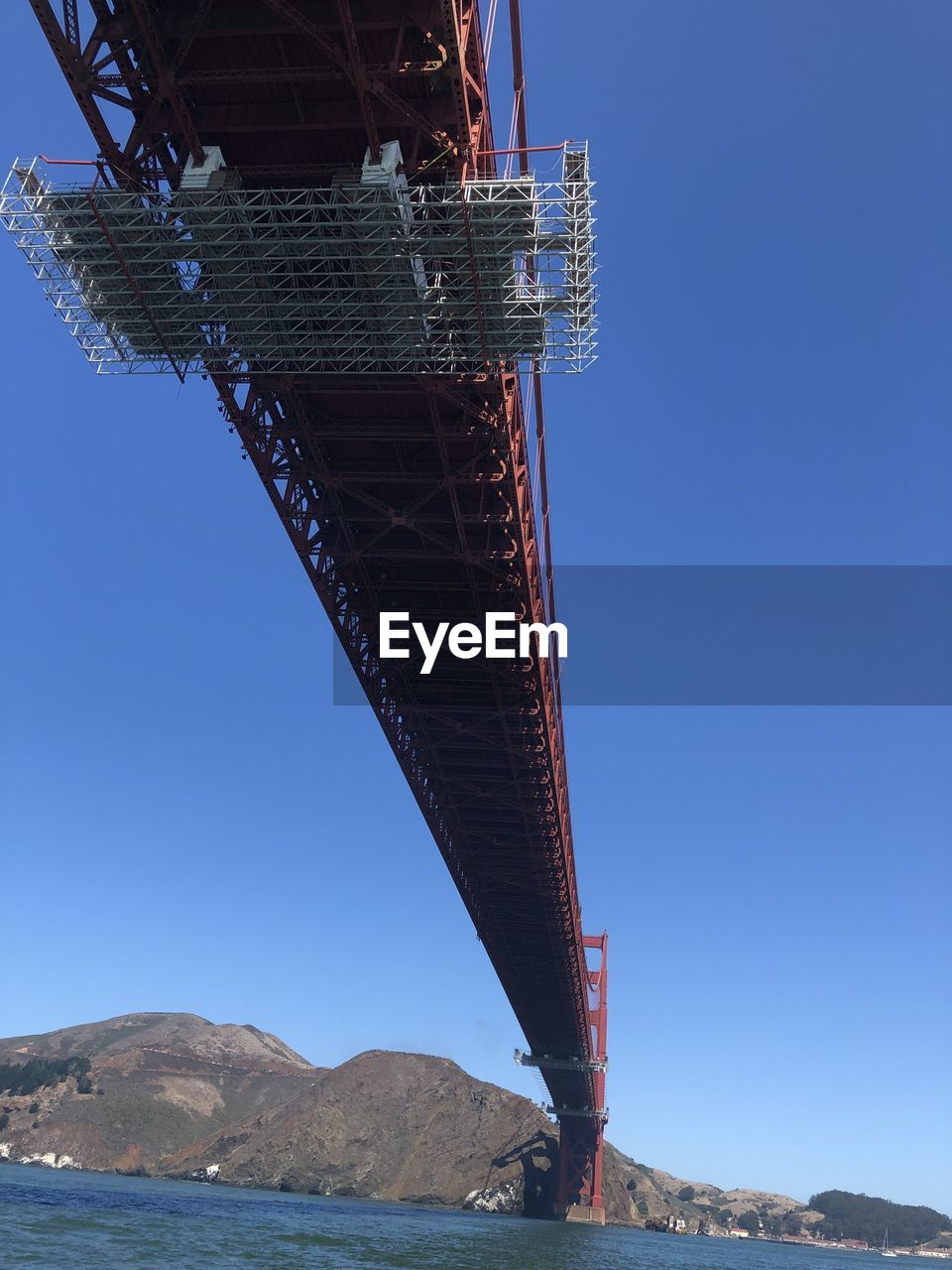 Low angle view of bridge against clear blue sky
