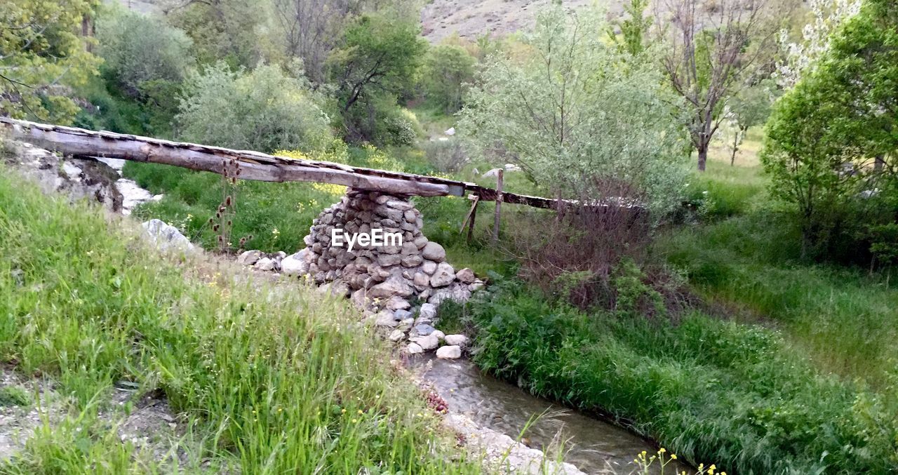 Narrow stream along countryside landscape