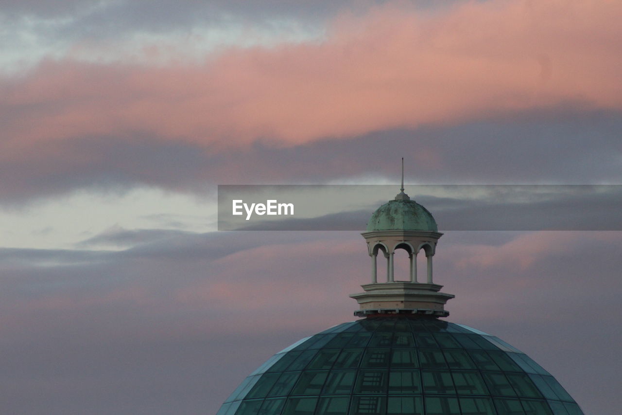 Dome against cloudy sky during sunset
