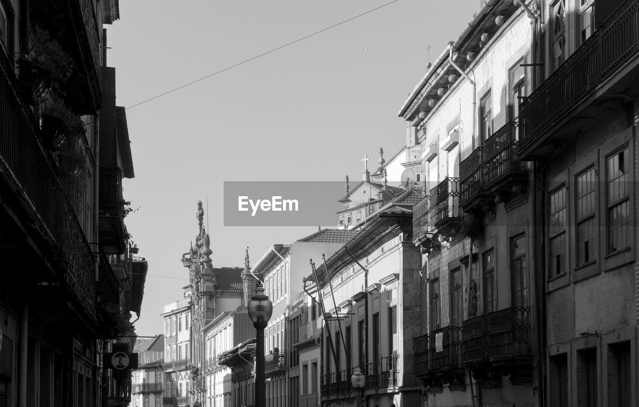 Low angle view of buildings in city against clear sky