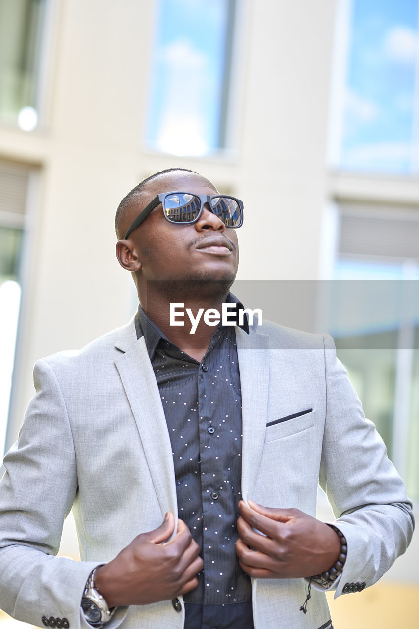 Stylish african american businessman posing with sunglasses.