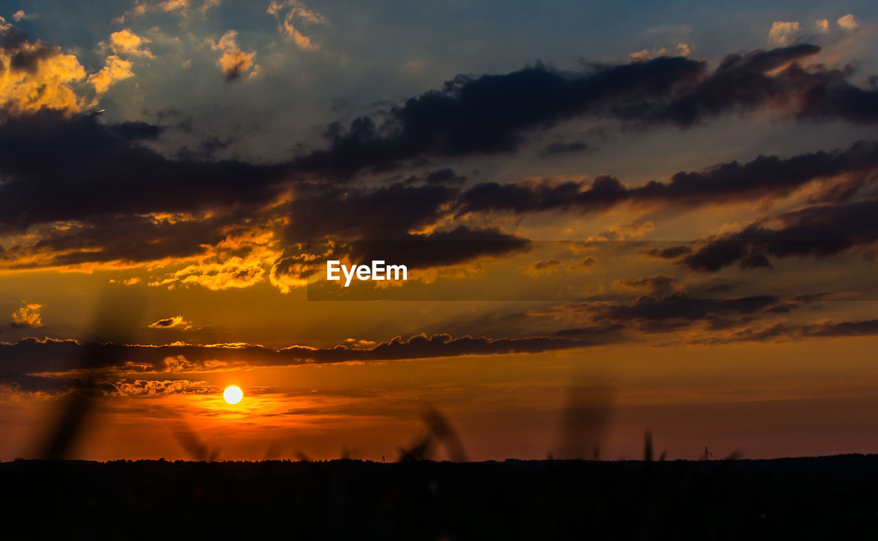 SILHOUETTE OF LANDSCAPE AGAINST CLOUDY SKY