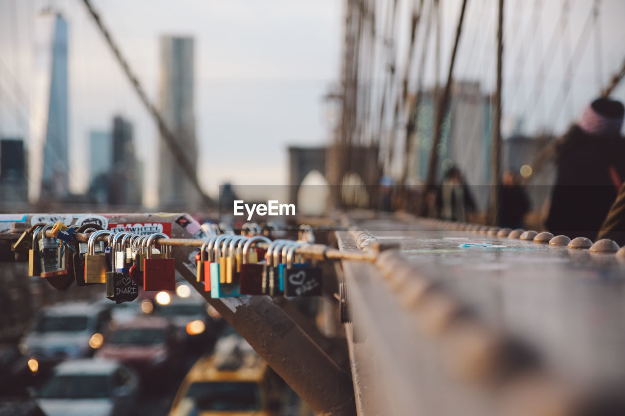 Close-up of love locks hanging on railing at brooklyn bridge