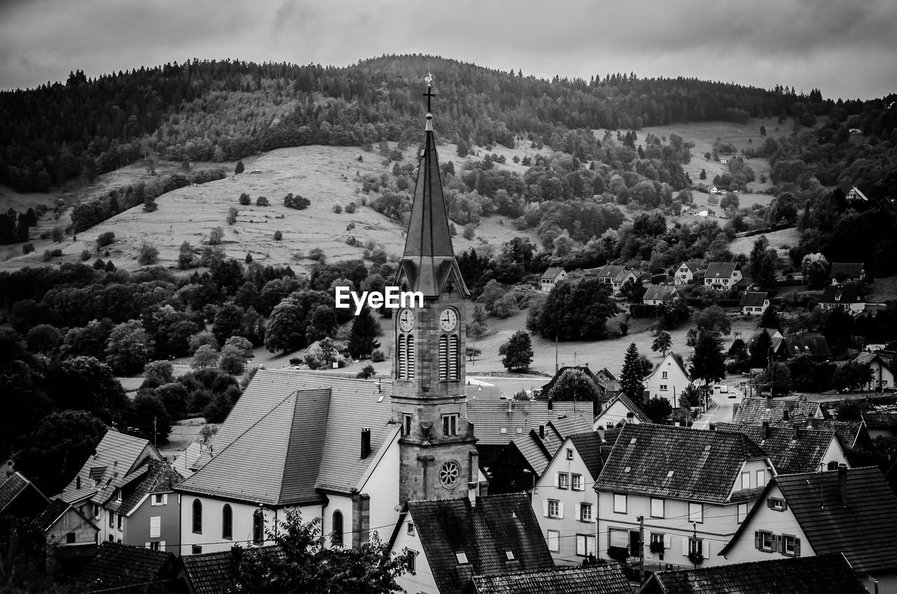 High angle view of church and houses against mountains