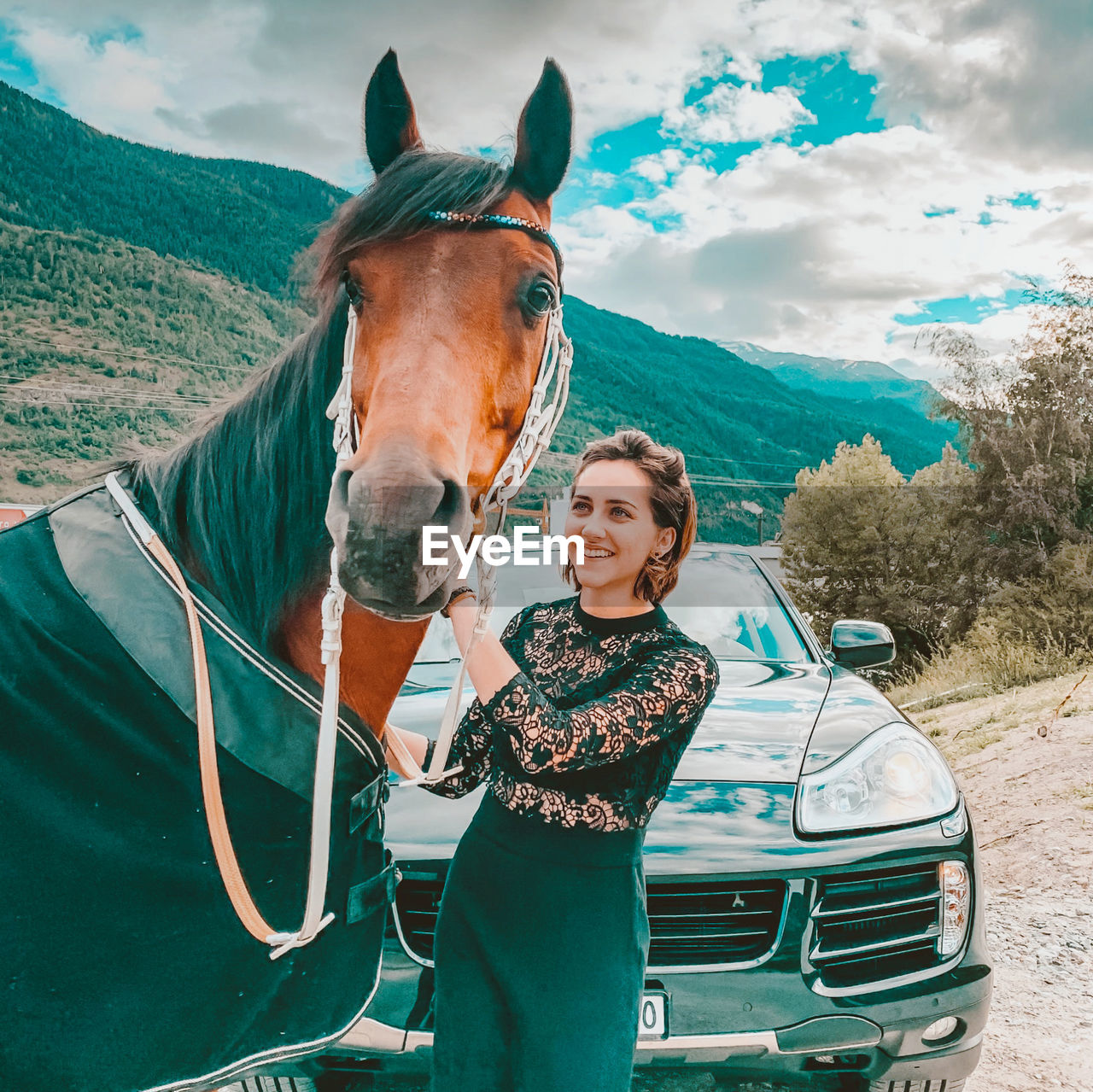 PORTRAIT OF YOUNG WOMAN WITH HORSE