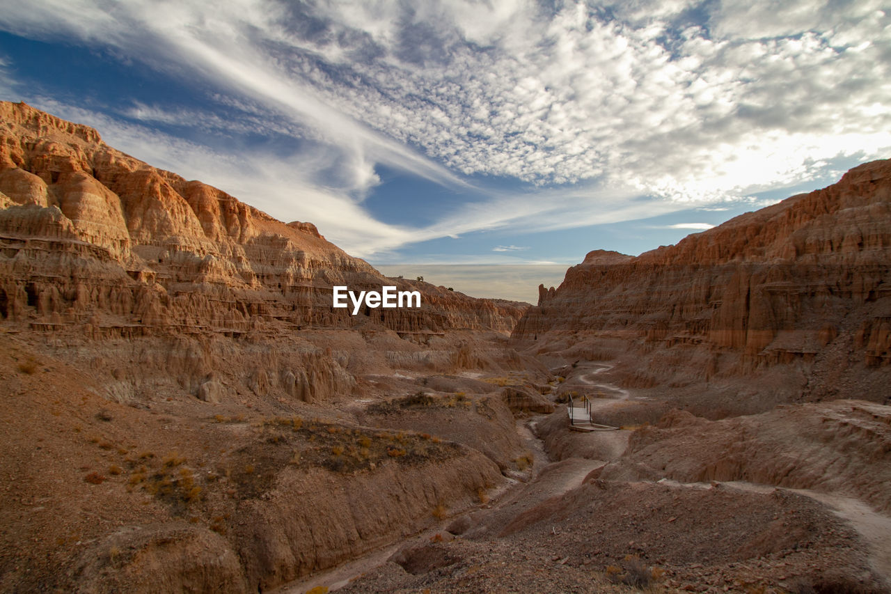 Scenic view of desert canyon against sky