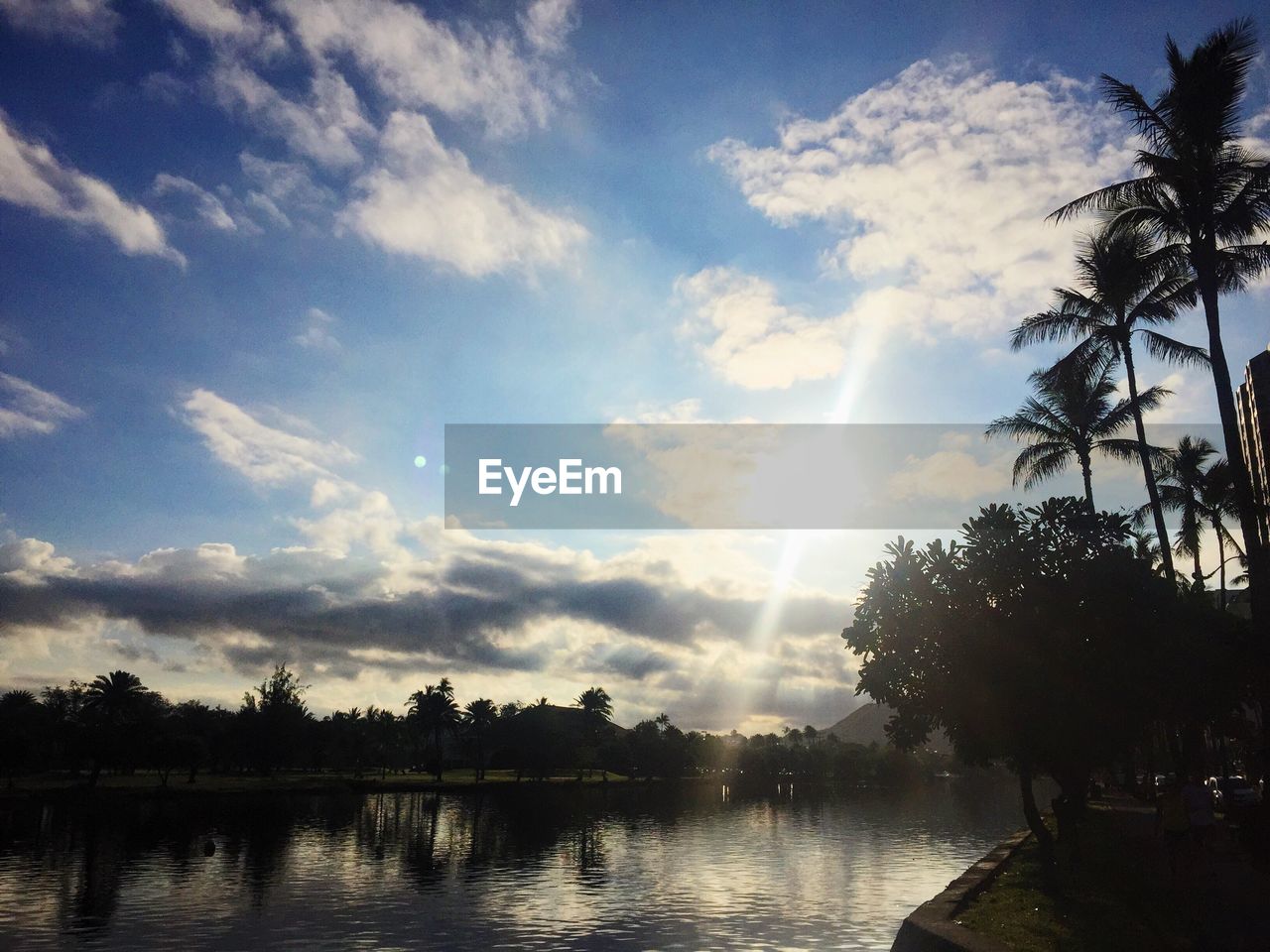 Scenic view of lake against cloudy sky