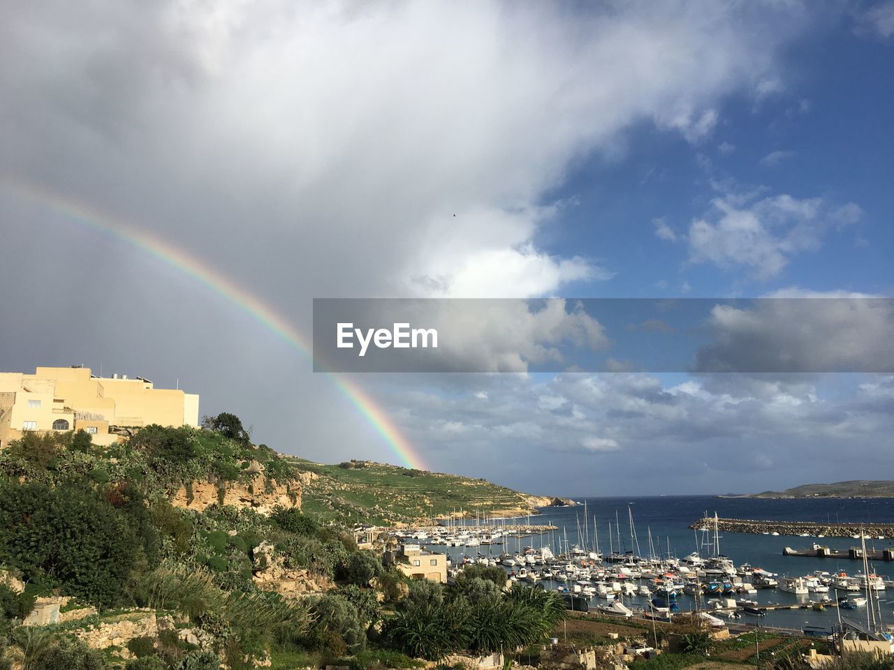 rainbow, sky, cloud, beauty in nature, nature, scenics - nature, water, architecture, environment, multi colored, land, landscape, double rainbow, horizon, city, building exterior, built structure, sea, tree, no people, plant, building, travel destinations, tranquility, storm, beach, outdoors, dramatic sky, idyllic, day, sunlight, mountain, natural phenomenon, travel, tranquil scene, tourism, spectrum, blue, summer, rain, overcast, cityscape, town, storm cloud