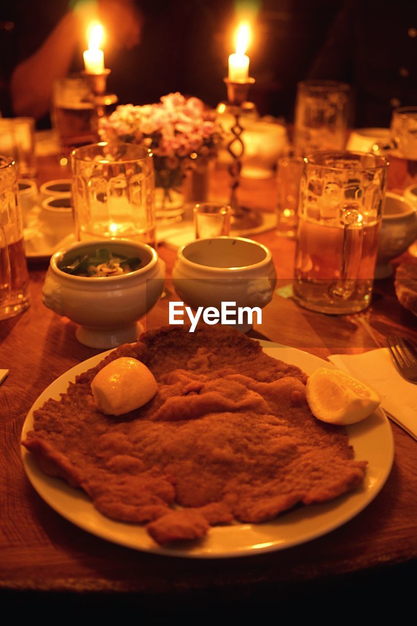 High angle view of schnitzel and beers on illuminated table