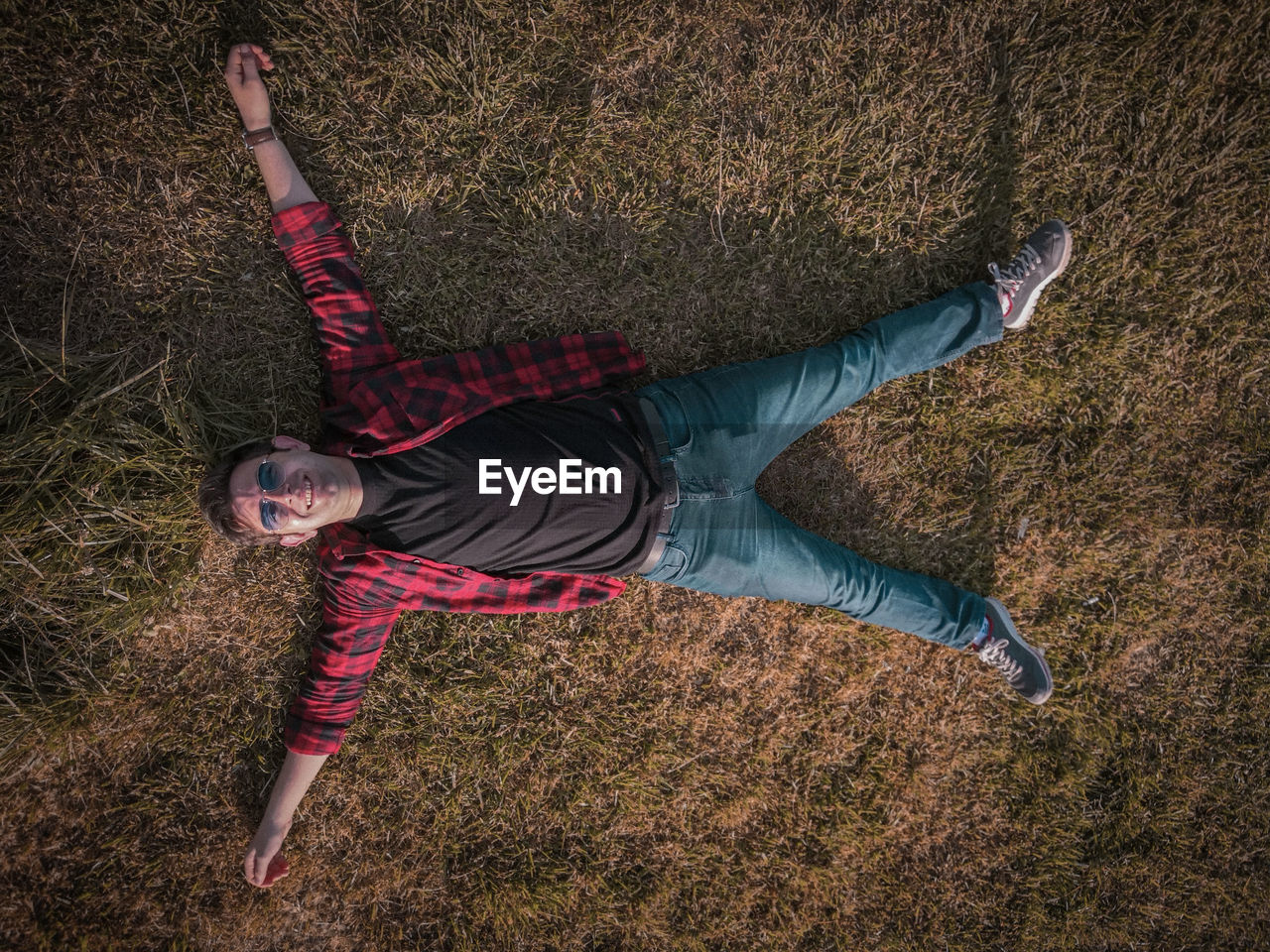 High angle view of person lying on field