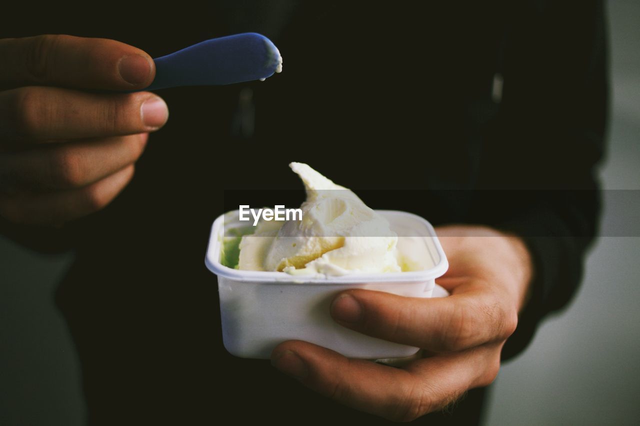 Midsection of man with ice cream