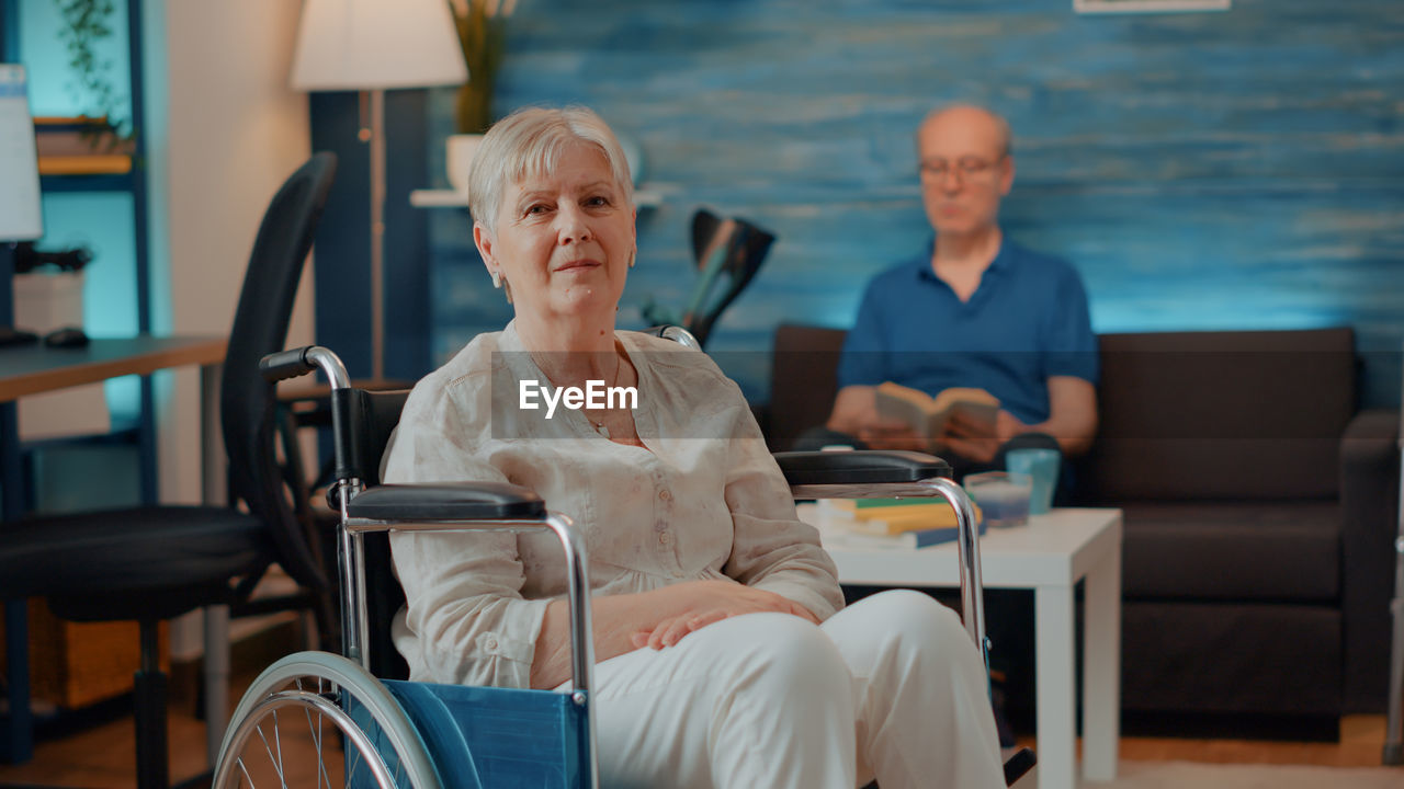 Portrait of senior woman sitting on wheelchair at home