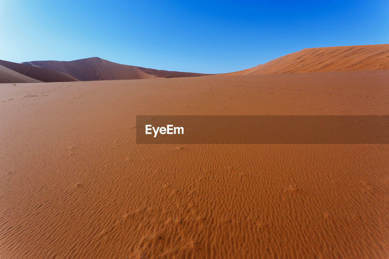 VIEW OF SAND DUNES IN DESERT