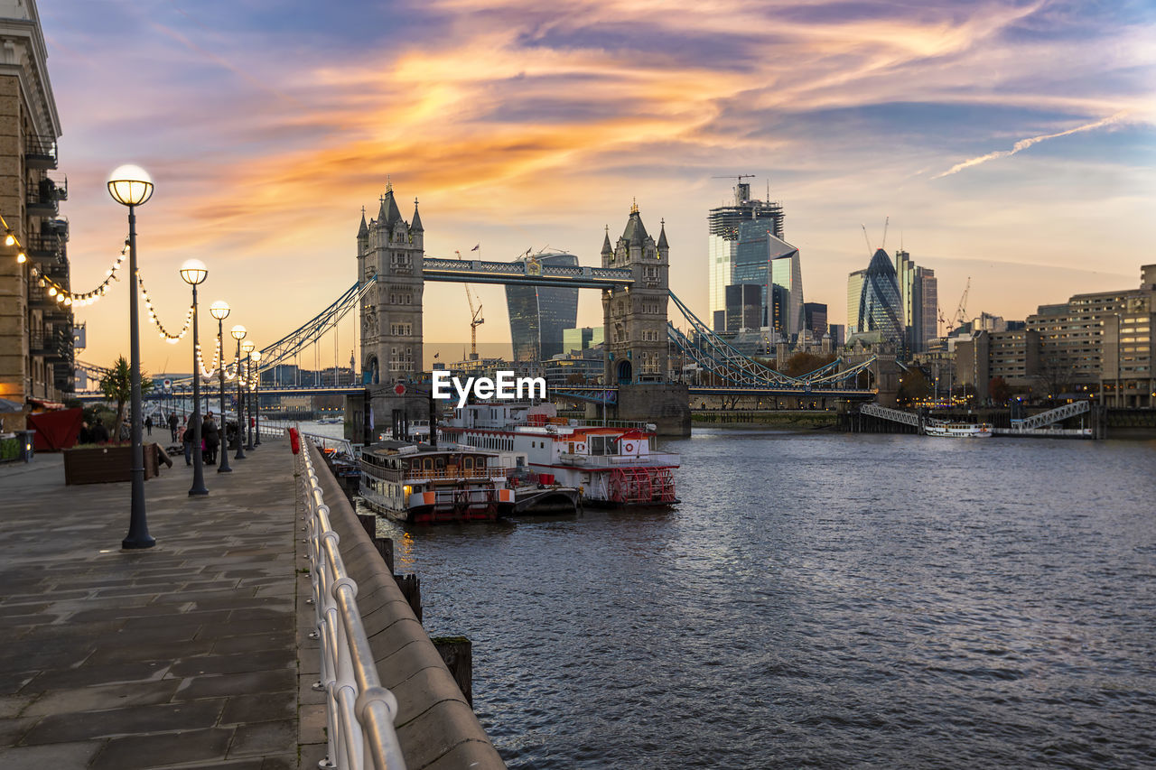 VIEW OF BRIDGE OVER RIVER AT SUNSET