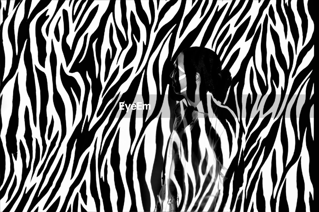 Digital composite image of woman against zebra print