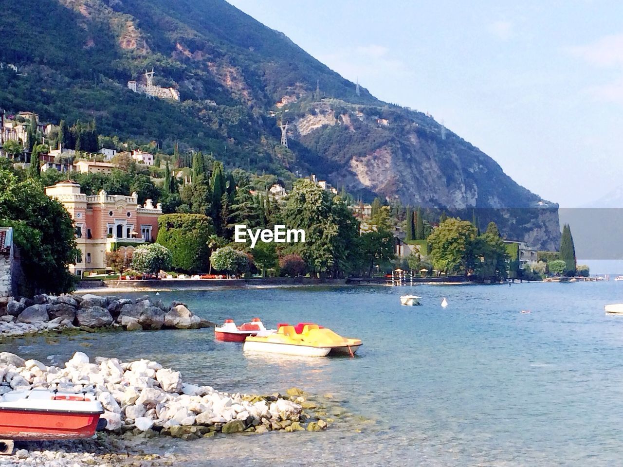 Boats on lake by mountain