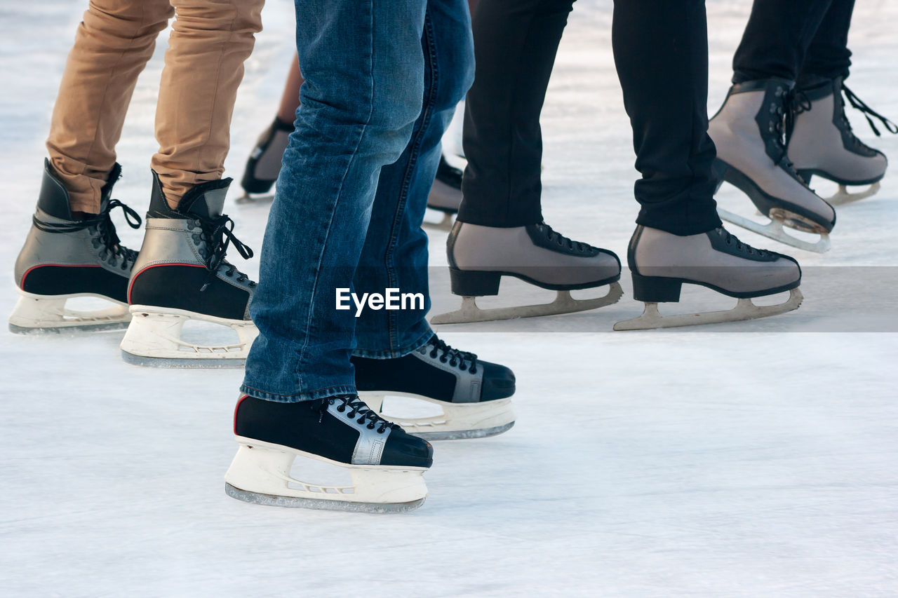 Low section of people skating on ice