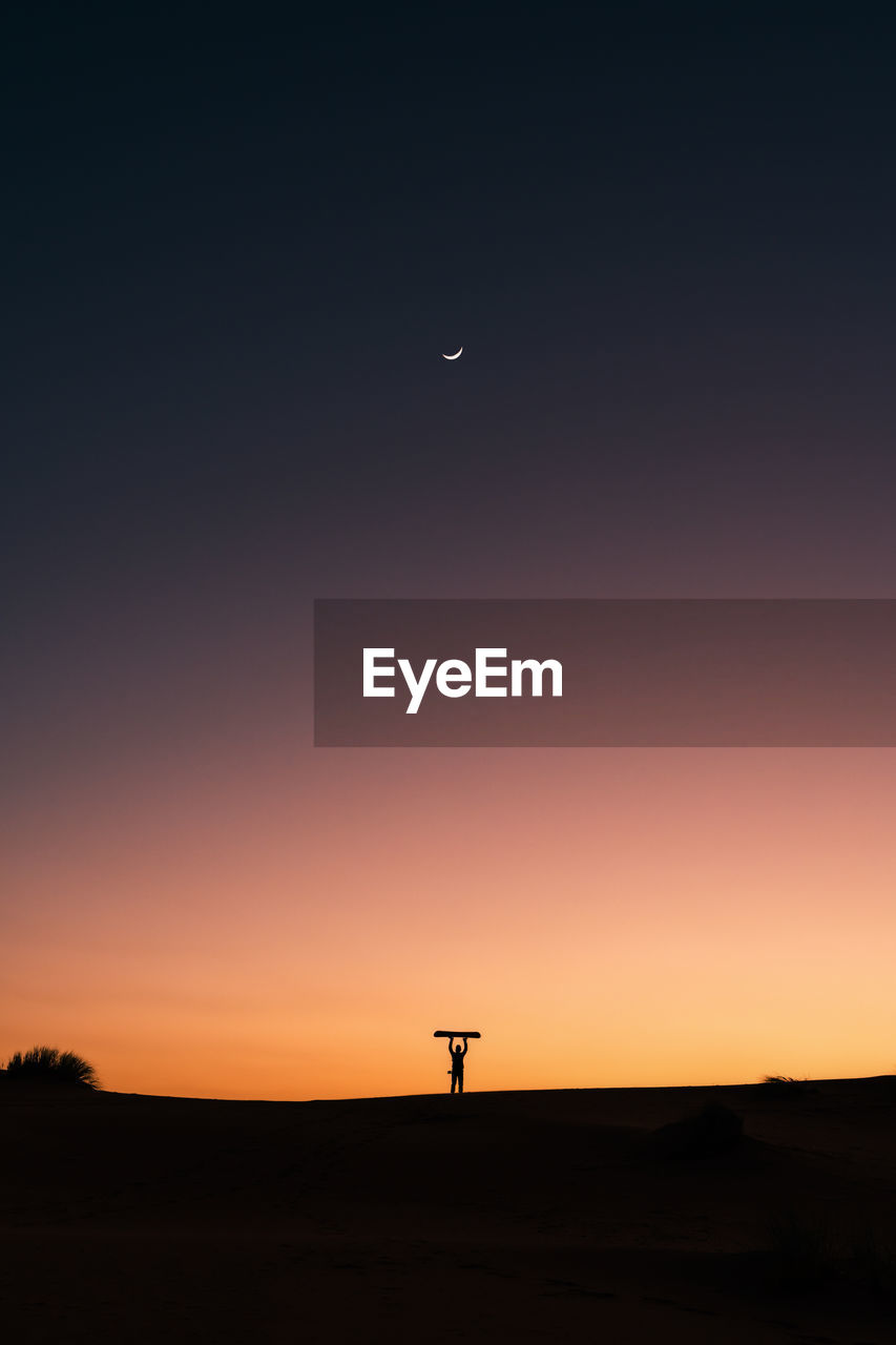 Silhouette landscape against sky during sunset